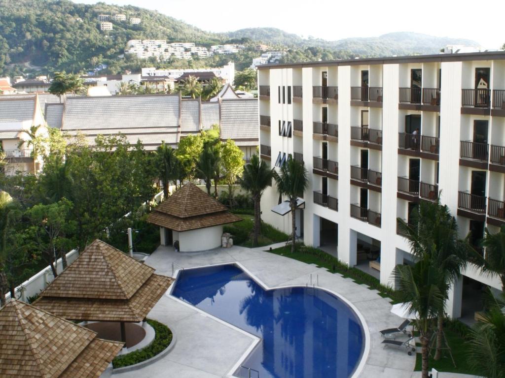 an aerial view of a building with a swimming pool at Ibis Phuket Kata in Kata Beach