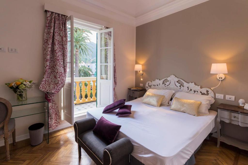 a bedroom with a white bed and a window at Mediterraneo Emotional Hotel & Spa in Santa Margherita Ligure