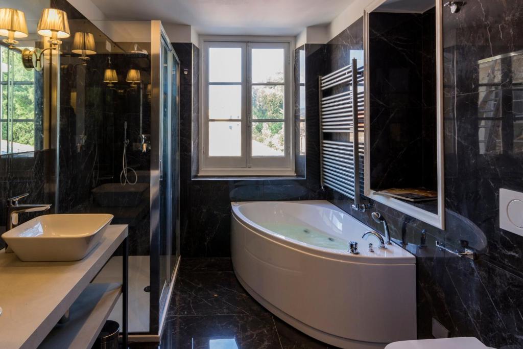 a large bathroom with a tub and a sink at Mediterraneo Emotional Hotel & Spa in Santa Margherita Ligure
