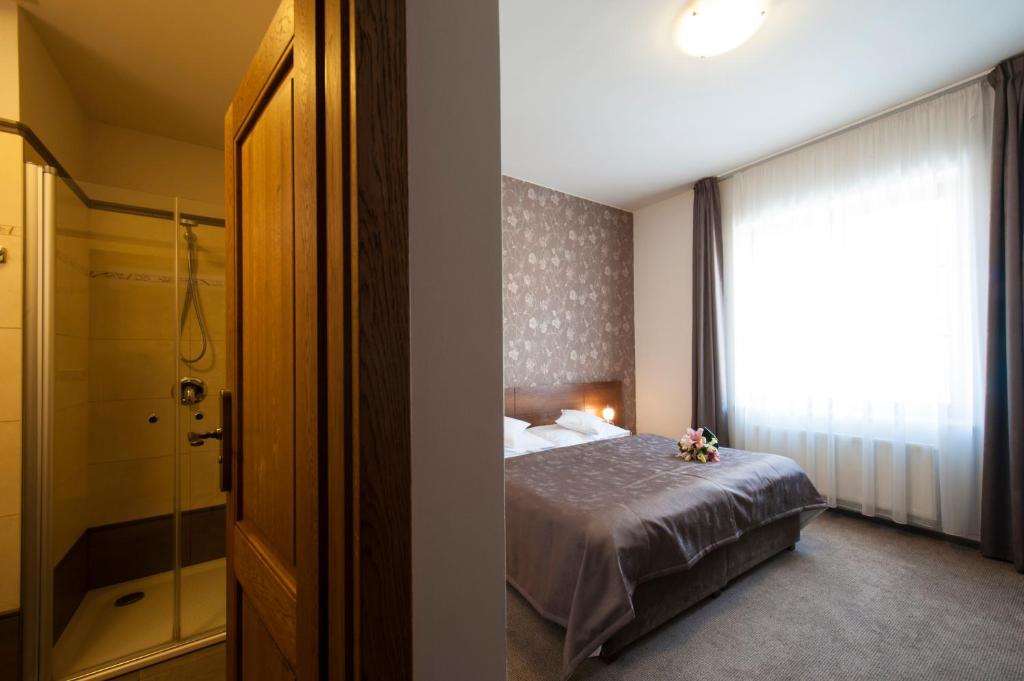 Postel nebo postele na pokoji v ubytování Hotel Mario