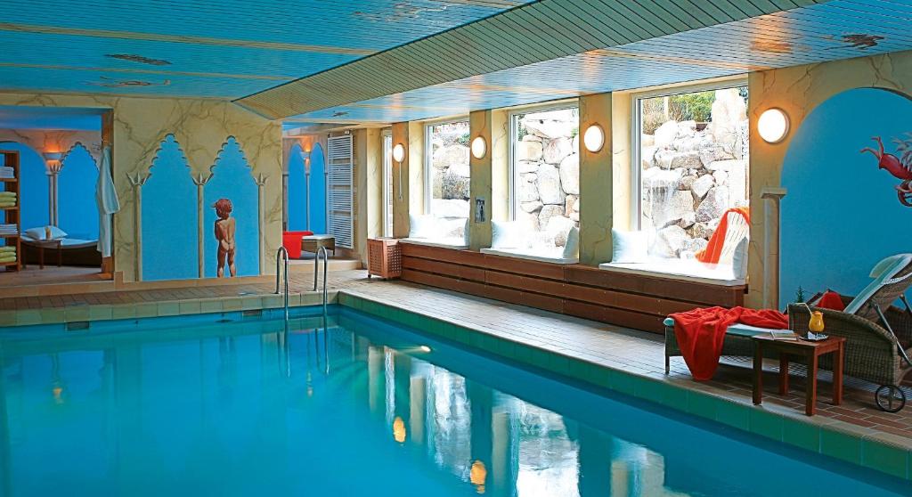 a large swimming pool in a house with a pool at Hotel Azenberg in Stuttgart