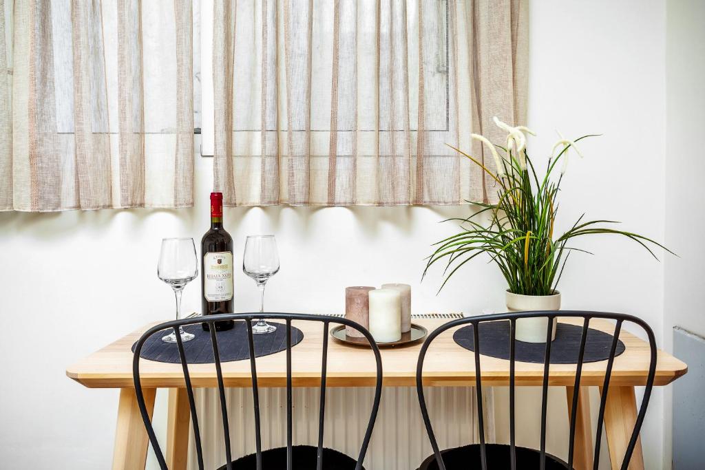 a table with a bottle of wine and two glasses at St Paul House in Thessaloniki
