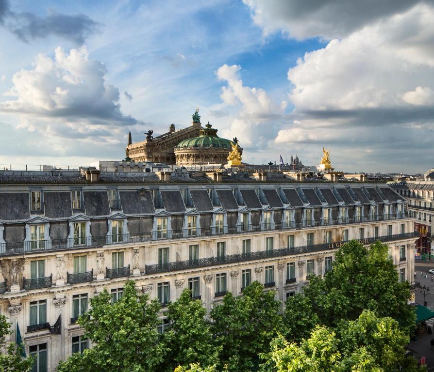 a large white building with a building in the background at Opera Lieu Unique in Paris