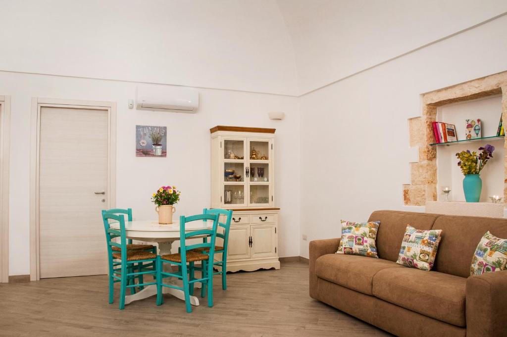 a living room with a table and chairs and a couch at Iannet & Co. in Locorotondo