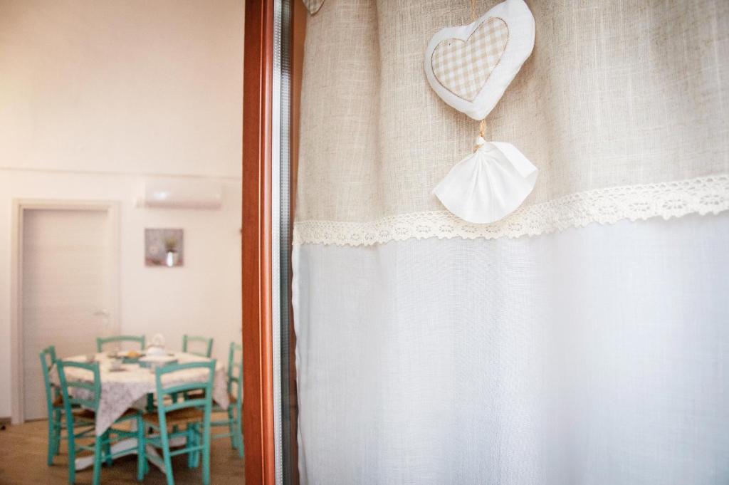 a heart ornament on a window with a table at Iannet & Co. in Locorotondo