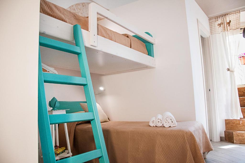 a green bunk bed in a small room with a bed at Iannet & Co. in Locorotondo