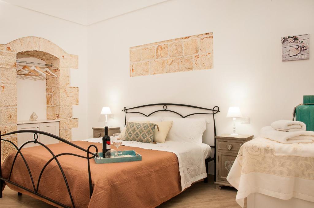a bedroom with two beds in a room with a brick wall at Iannet & Co. in Locorotondo