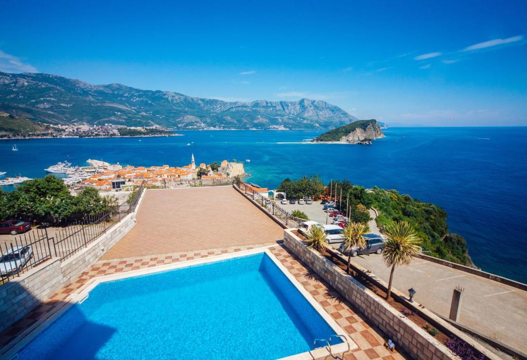 a swimming pool with a view of the ocean at Vidikovac Marble House in Budva