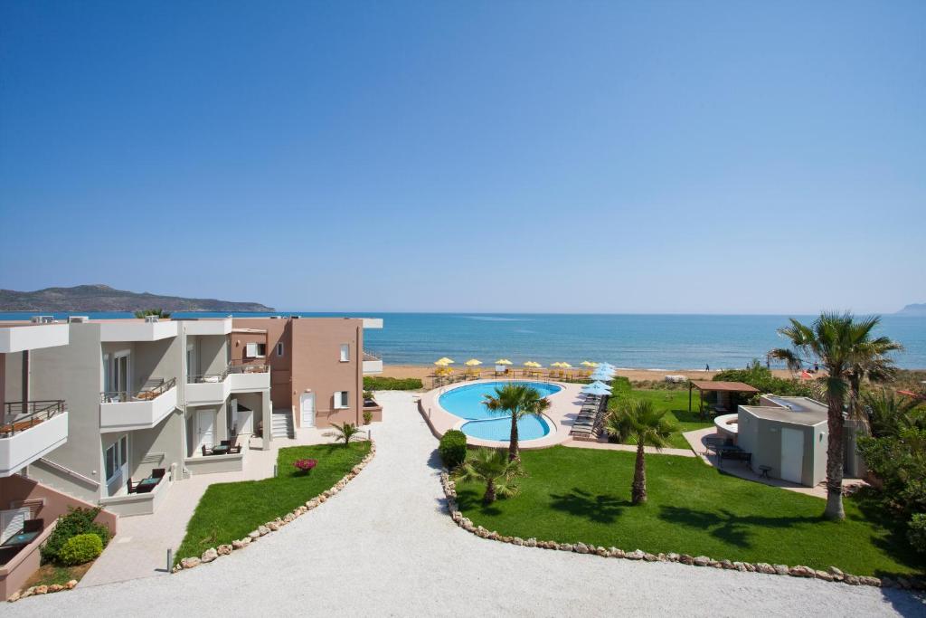 an image of a villa with a swimming pool and the ocean at Phaedra Hotel in Stalos