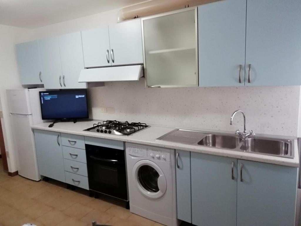 a kitchen with a stove and a sink and a dishwasher at Casa vacanze Maria Chiara in San Benedetto del Tronto