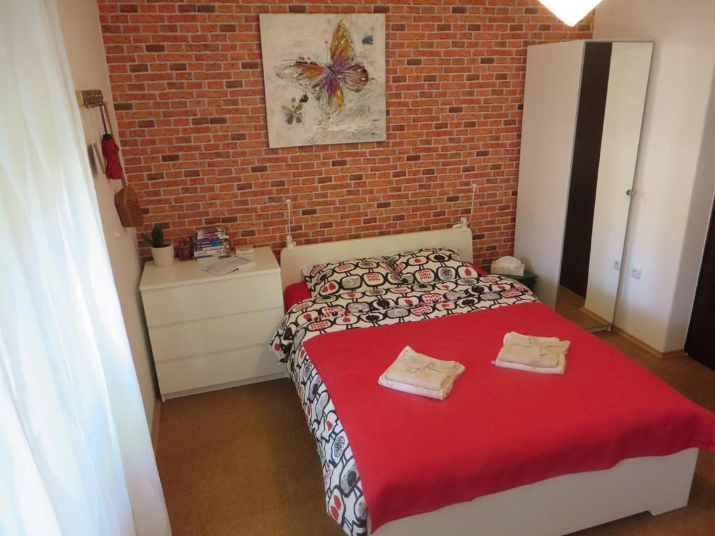 a bedroom with a bed and a brick wall at Apartment Lucia in Sveti Križ Začretje