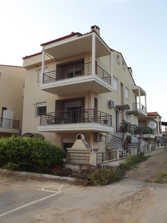 a building with balconies on the side of it at Kalives Summer House in Kalivia Poligirou