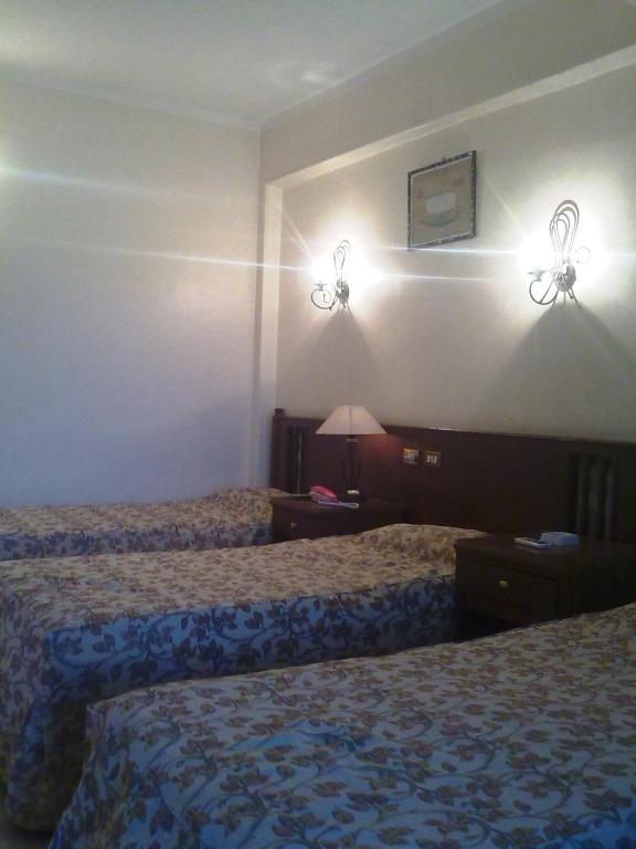 Postel nebo postele na pokoji v ubytování Orchida St. George Hotel