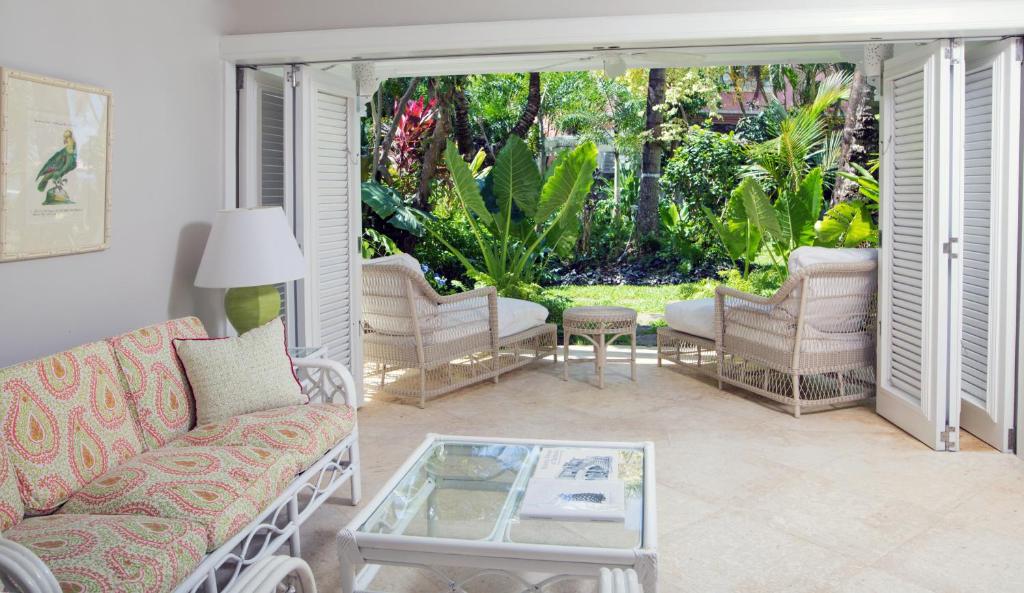 a living room with a couch and a coffee table at Cobblers Cove - Barbados in Saint Peter