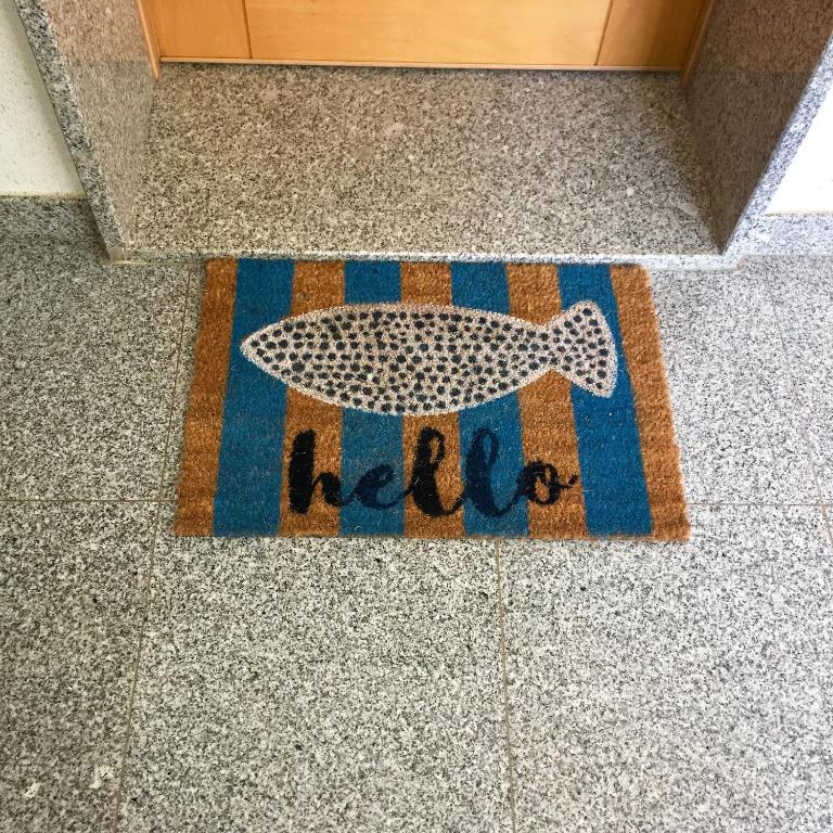 a fish rug on a floor with the word help at Âncora Boutique Apartments in Lagos