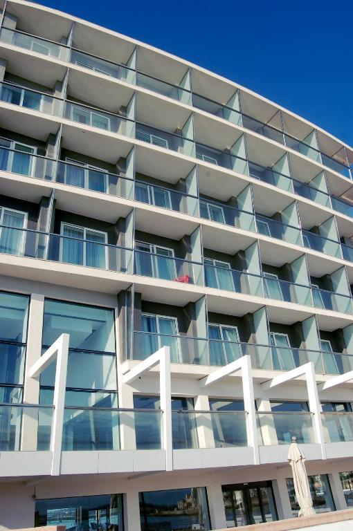 an apartment building with the number on it at Water's Edge Hotel in Birżebbuġa