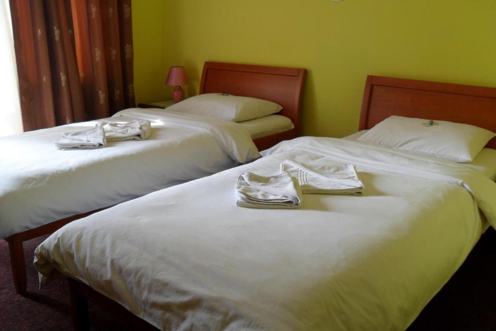 Postel nebo postele na pokoji v ubytování Hotel Vila Sunce