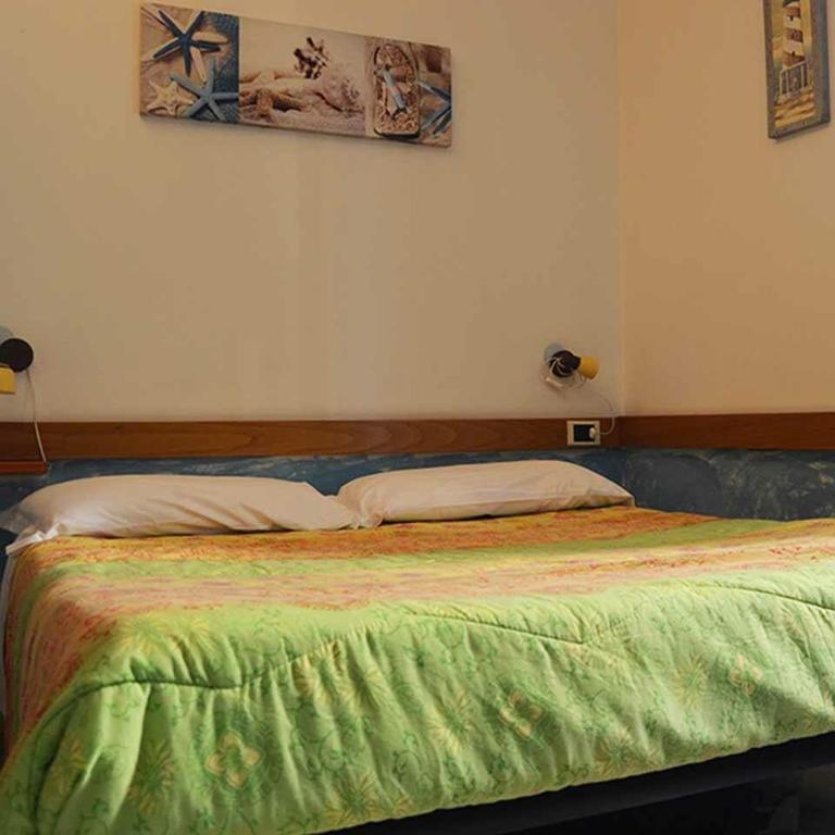 A bed or beds in a room at Affittacamere La Baia Di Lerici