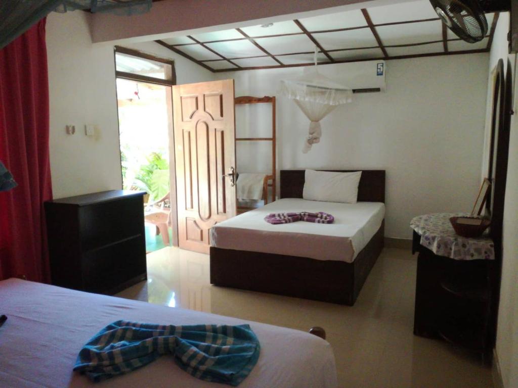 Postel nebo postele na pokoji v ubytování Sigiriya River Side Resort