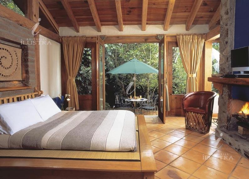 a bedroom with a bed and a table with an umbrella at Las Galeritas de San Sebastian in San Sebastián del Oeste