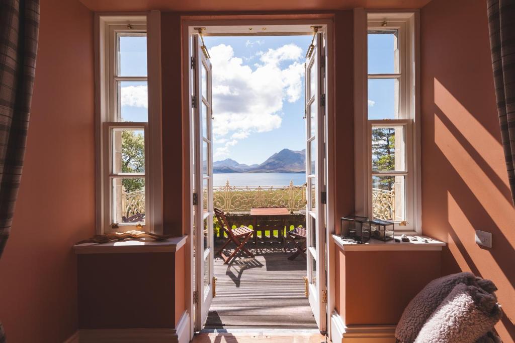 a hallway with windows and a view of the ocean at Raasay House Hotel in Raasay