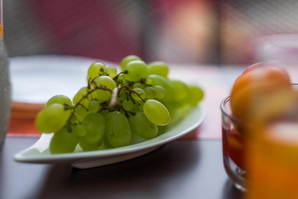a plate of green grapes on a table at Apartments Stasic in Vrbnik