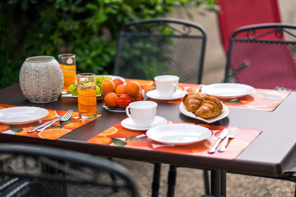 a table with plates of food and fruit on it at Apartments Stasic in Vrbnik