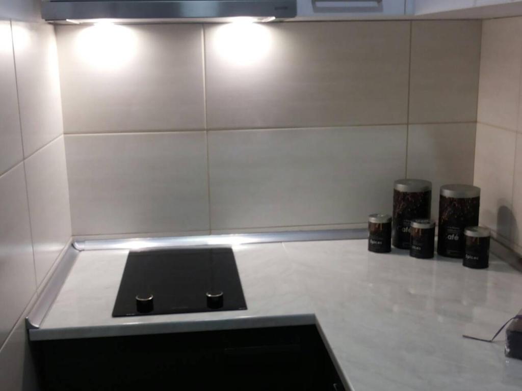 a room with a counter with three trash cans at Apartmani F&A in Zlatibor
