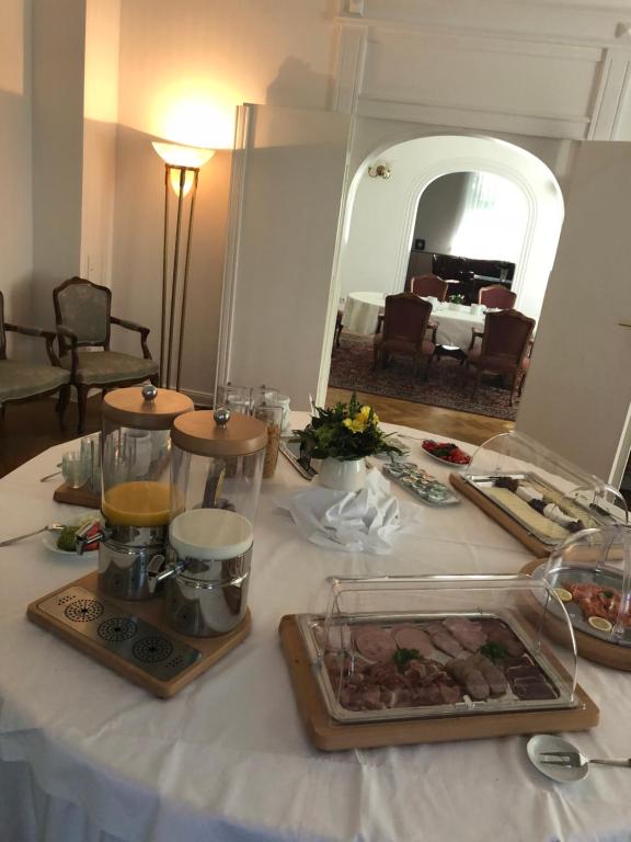 a table with some food on it with a mirror at Gästehaus Leipzig in Leipzig