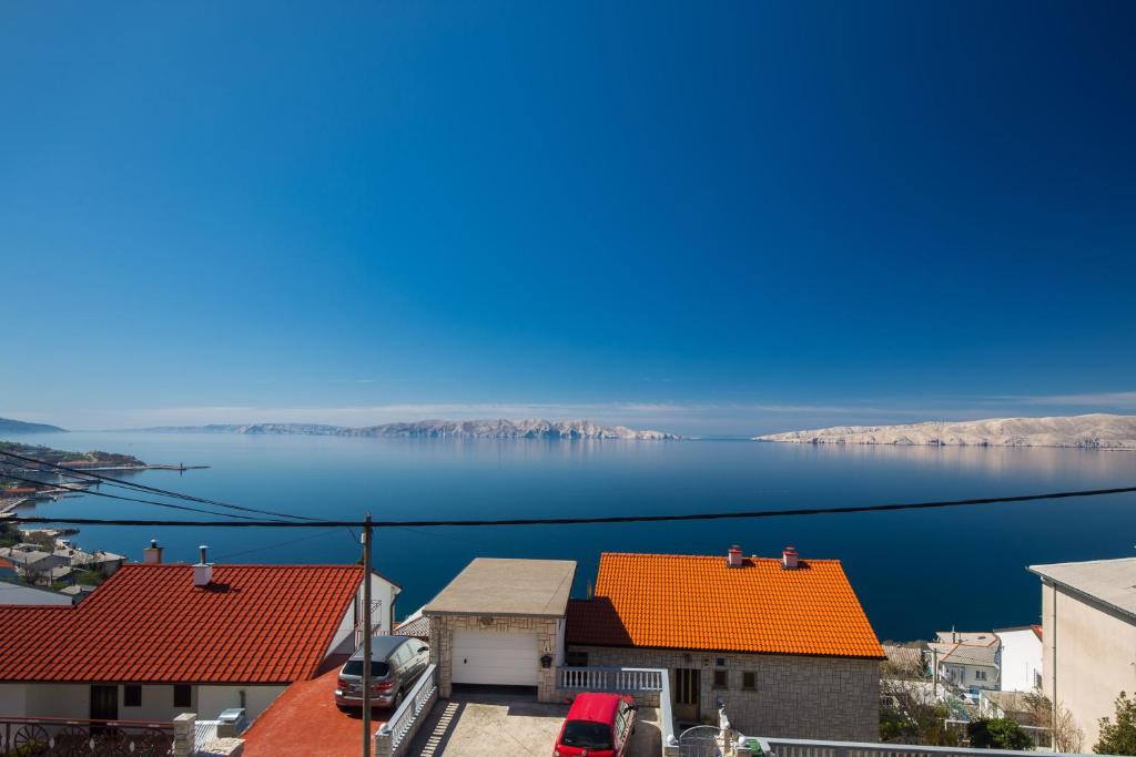 a view of a body of water with orange roofs at Vuk Apartman in Senj