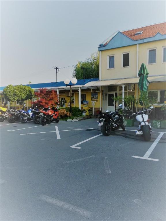 a parking lot with motorcycles parked in front of a building at Moto klub Brod in Slavonski Brod