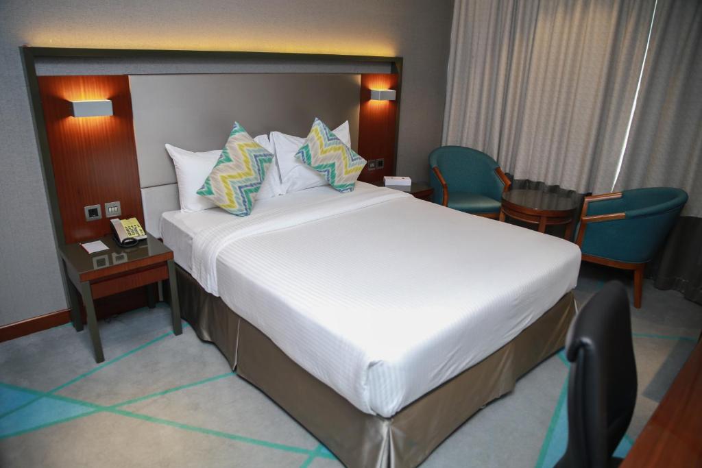 Postel nebo postele na pokoji v ubytování Versailles by Vieras Hotel