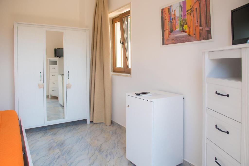 a room with a white cabinet and a mirror at Hotel San Giovanni in Polignano a Mare