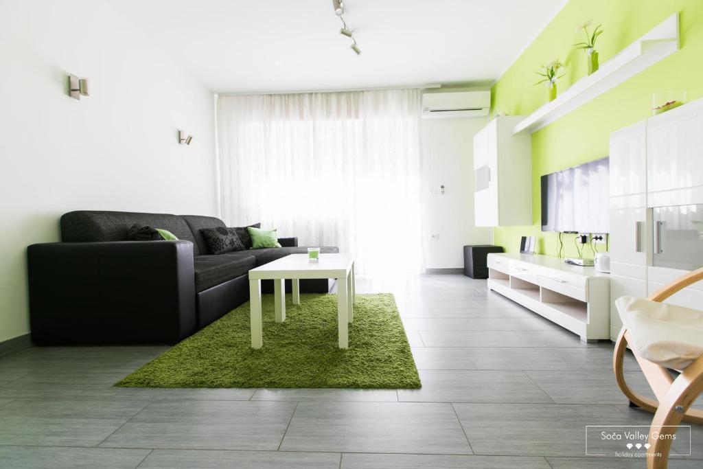 sala de estar con sofá y mesa en Emerald Soca Apartment en Tolmin