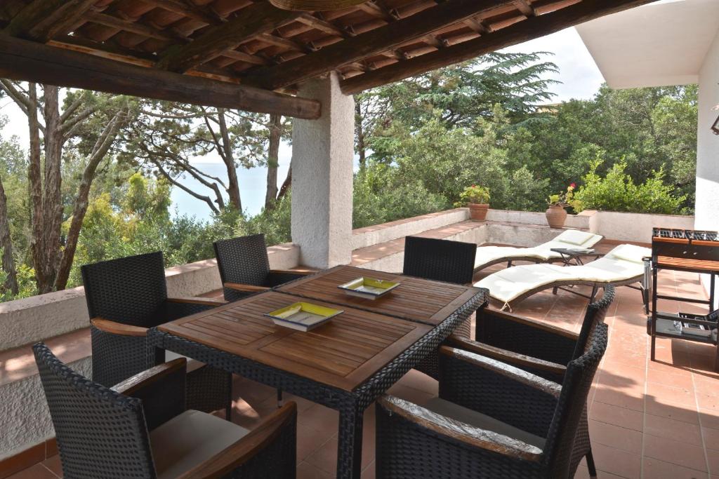 a wooden table and chairs on a patio at Villa Maratea in Marina