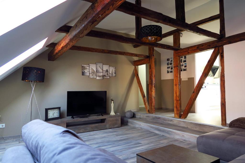 a living room with a couch and a flat screen tv at Ferienwohnung "Eisenach Stadtmitte" in Eisenach