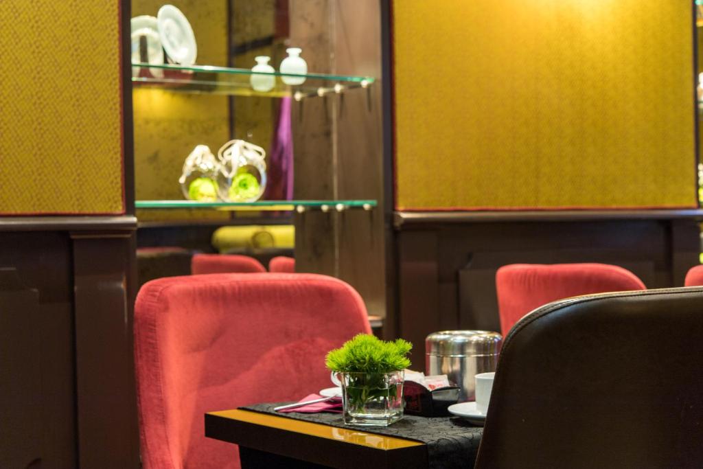 a dining room with red chairs and a table at Hotel Campiello in Venice