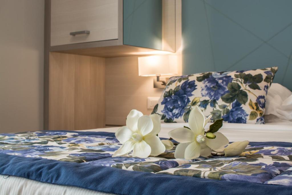 Postel nebo postele na pokoji v ubytování Hotel Doriana