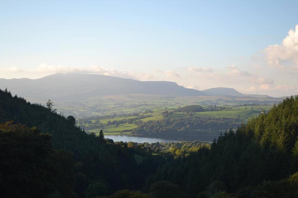 a view of a valley with a lake and mountains at Glyn Mawr Barn in Bala