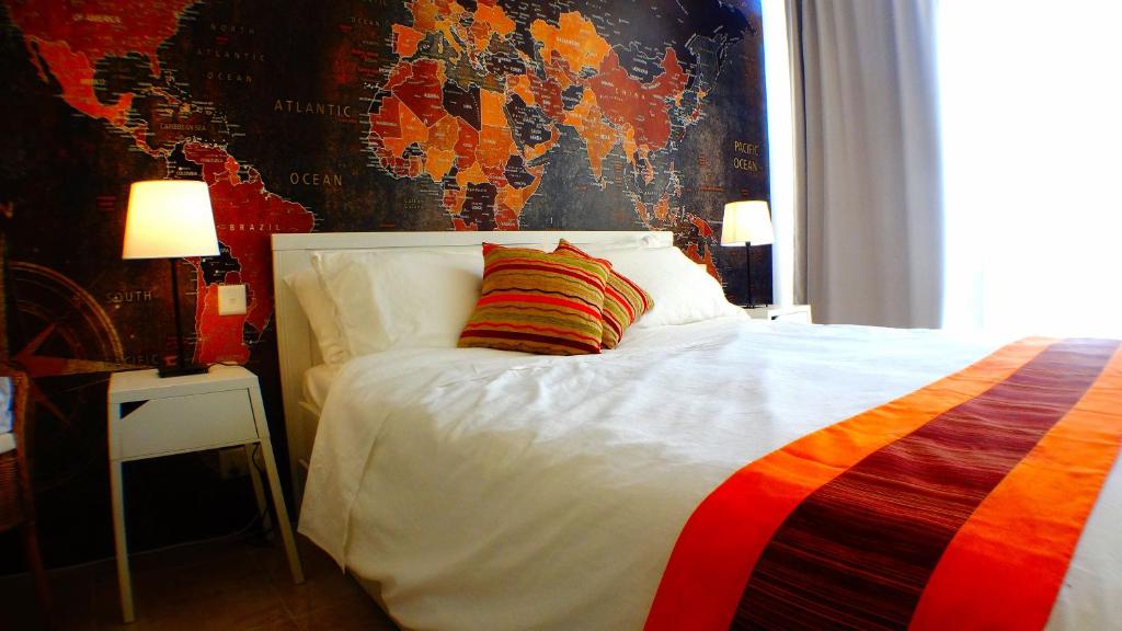 a bedroom with a white bed with a colorful pillow at R1103ERI by euroresort in Marsalforn
