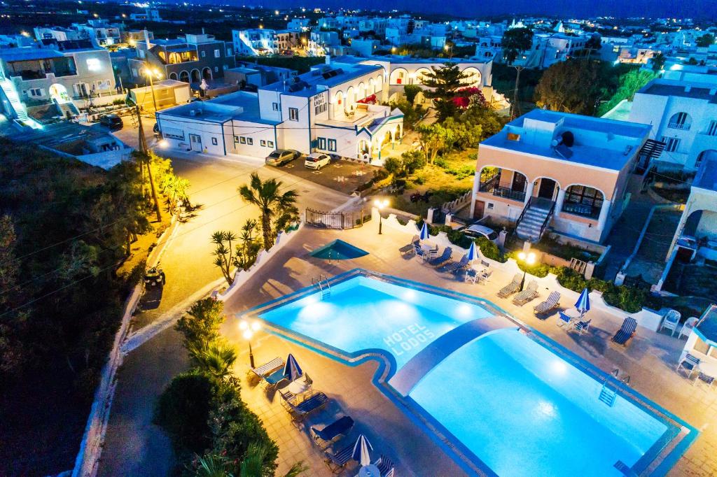 an aerial view of a villa with a swimming pool at night at Hotel Lodos in Karterados