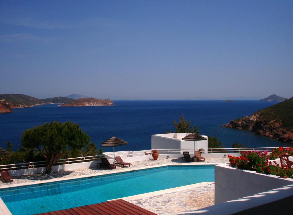 a swimming pool with a view of the ocean at Patmos Paradise Hotel in Kámbos