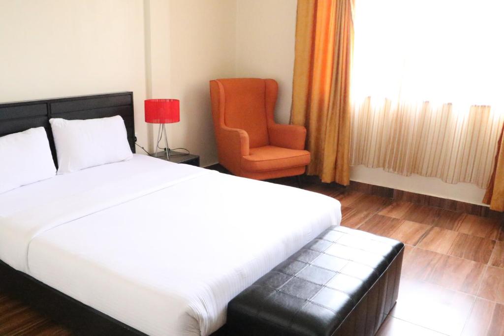 Postel nebo postele na pokoji v ubytování Gigiri Express Hotel