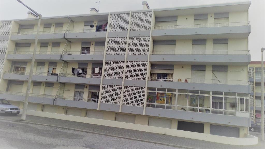 an apartment building with people on the balconies at Casa da Praia de Peniche in Peniche
