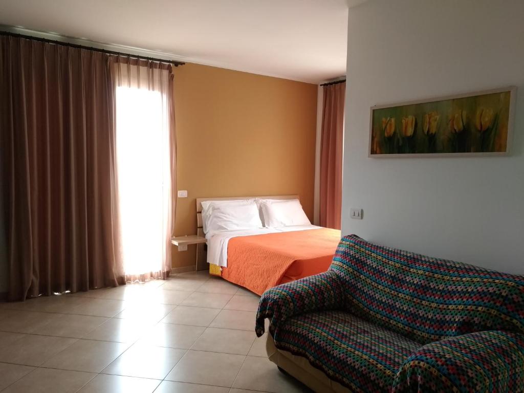 Łóżko lub łóżka w pokoju w obiekcie Residence Ilario Suite Hotel