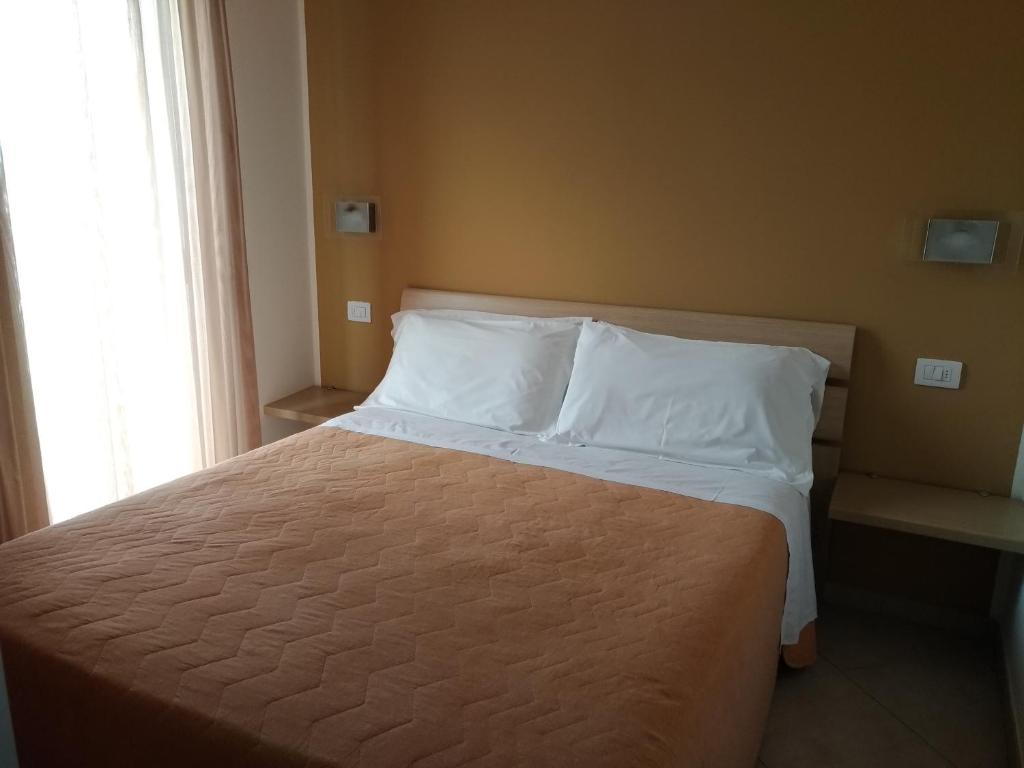 Łóżko lub łóżka w pokoju w obiekcie Residence Ilario Suite Hotel