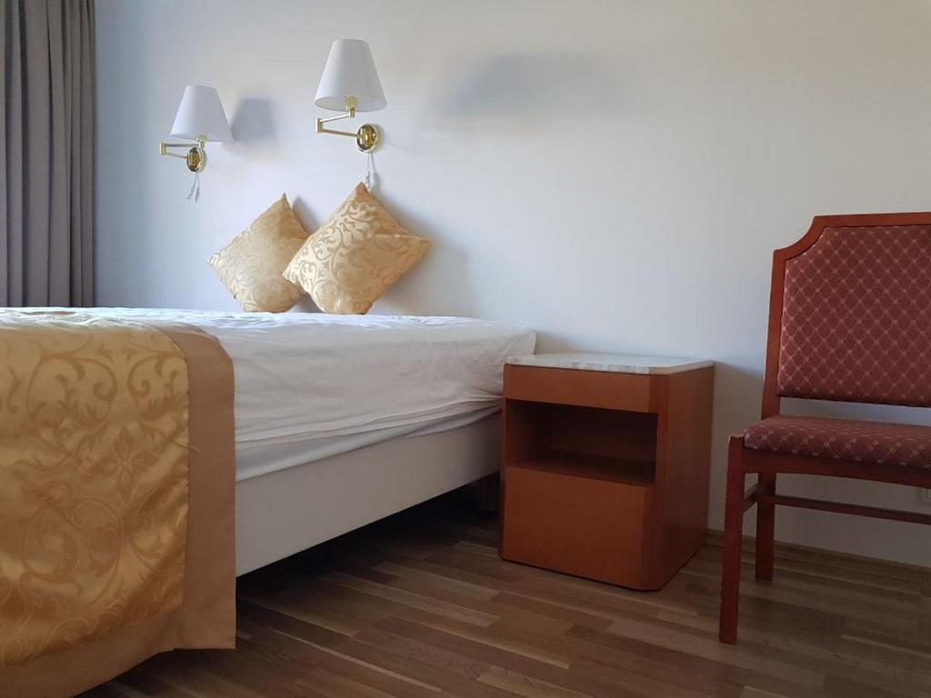 Postel nebo postele na pokoji v ubytování Hótel Bjarkalundur