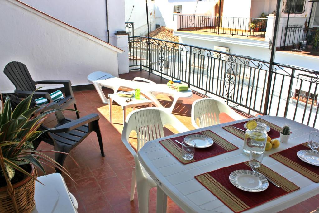 patio con mesa y sillas en el balcón en Casa Tita Laura, en Algarrobo