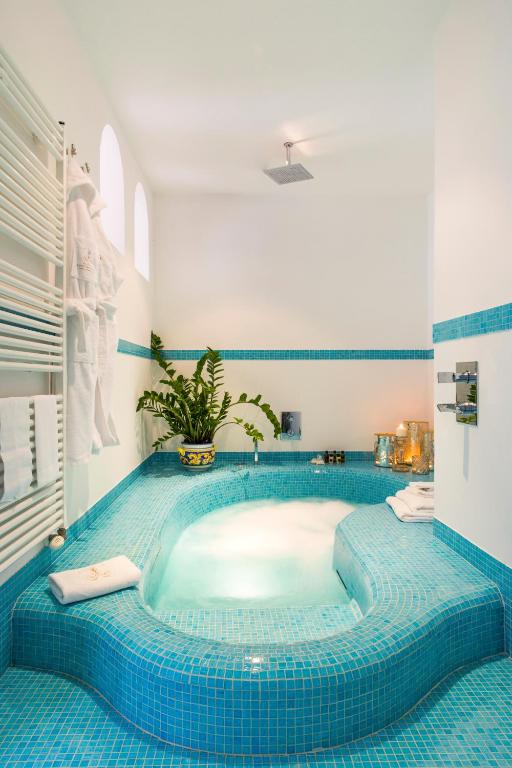 a bath tub in a room with blue tiles at Hotel Piccolo Sant'Andrea in Praiano