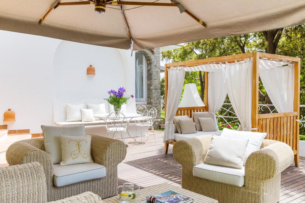 a patio with chairs and a table with a tent at Hotel Piccolo Sant'Andrea in Praiano